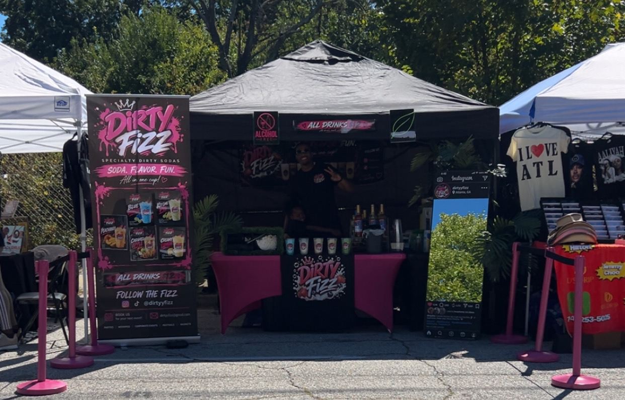 The Dirty Fizz booth: black tent, hot pink tables and pink stanchions